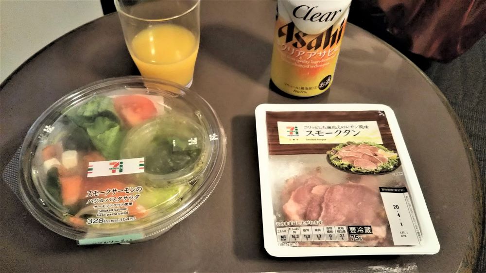 Simple convenience store dinner in a hotel room during a solo trip in Japan