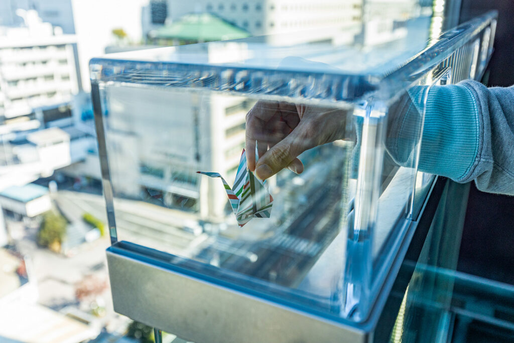 Orizuru Tower experience in Hiroshima, folding and placing origami cranes