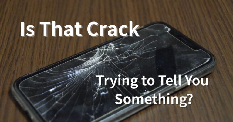A cracked smartphone screen with visible damage, symbolizing a possible message or meaning